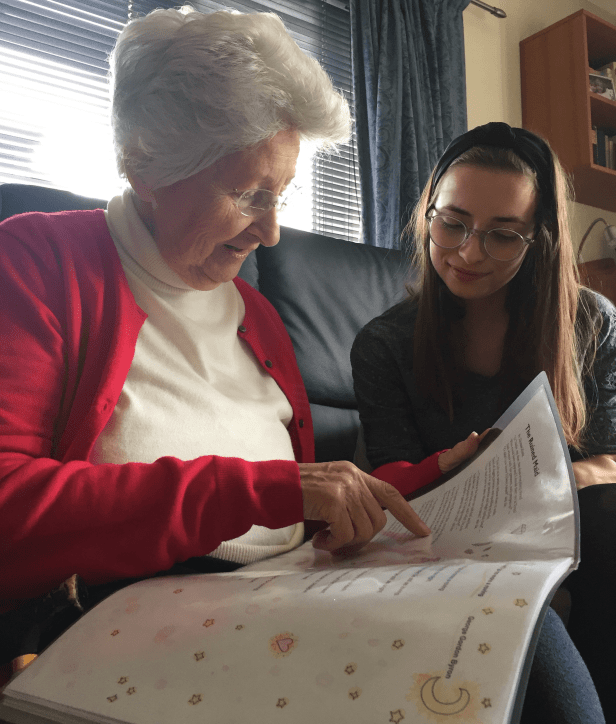 My Mum and her grandaughter Emily smiling and reading poetry